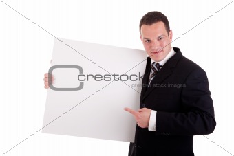 handsome businessman holding a whiteboard and pointing, looking at the camera and smiling, isolated on white, studio shot