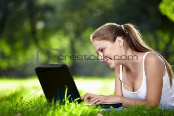 Girl with a laptop in the park