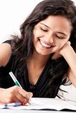 Tense beautiful indian girl writing on paper