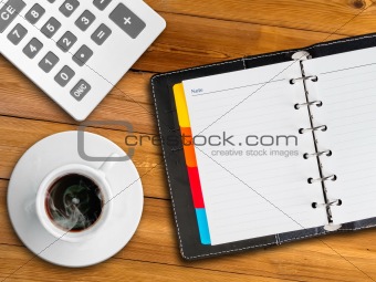 white notebook and white cup of hot coffee