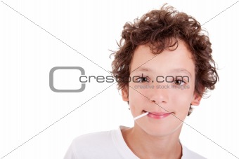Cute Boy with a candy on mouth smiling, isolated on white, studio shot