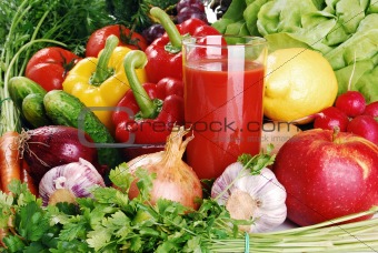 Composition with fresh raw vegetables and glass of juice