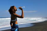 young mixed girl drinking water