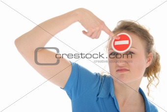 Young woman holds prohibiting sign before forehead