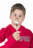 Boy looks at a fork