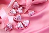 Valentine's chocolate hearts on pink satin