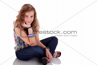 beautiful blonde young woman sitting on floor, isolated on white, studio shot