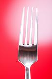 Silver fork against gradient color background