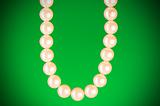 Pearl necklace against colourful background