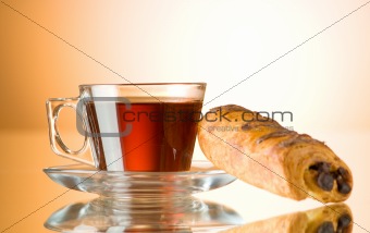 Tea and croissants on the reflective background