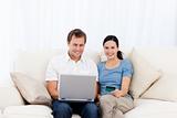 Happy couple buying online with laptop and credit card 