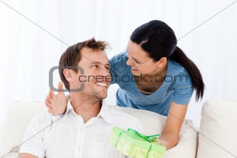 Happy man receiving a present from his girlfriend