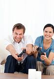 Excited man playing video games wth his girlfriend