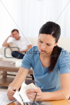 Angry woman doing her account while her boyfriend waiting