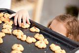 Close up of a little girl taking a cookie