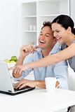 Happy woman showing something on the laptop to his boyfriend