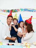 Portrait of parents with their children during a birthday party