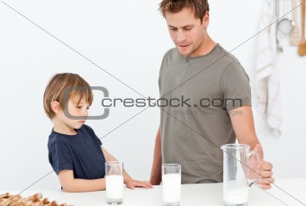 Cute dad and son drinking milk together
