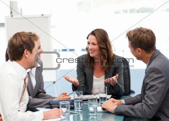 Attractive businesswoman laughing with her team