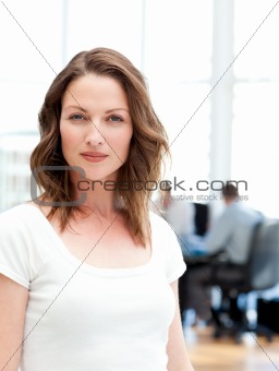 Confident businesswoman standing in front of her team while work