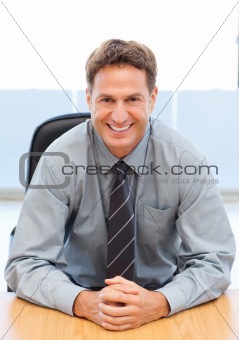 Happy manager sitting at a table