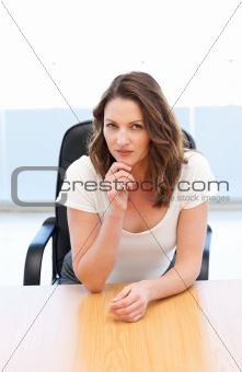 Pensive businesswoman sitting at a table