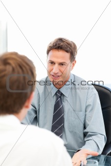Serious manager talkin witthh anemployee during an interview