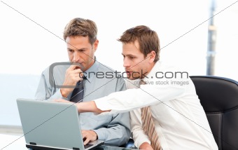 Two handsome businessmen working together on a project 