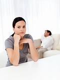 Worried woman in the living room while her boyfriend sleeping