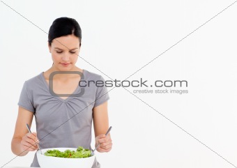 Pretty woman preparing a salad with tomatoes in the kitchen 