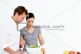 Active couple preparing a salad for lunch