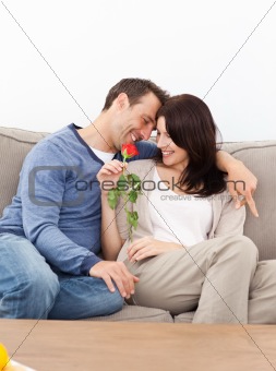 Enamored couple sitting together on the sofa
