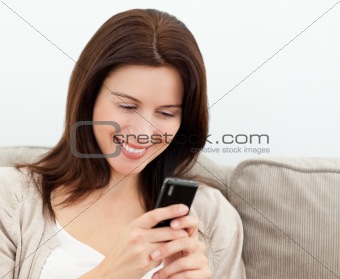 Attractive woman reading a sms on  her mobile phone 