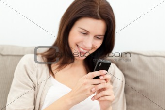 Beautiful woman reading a message on her mobile phone