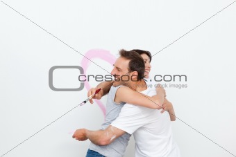 Lovely couple hugging while renovating their bedroom