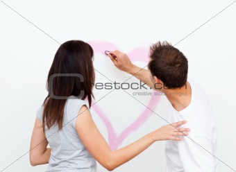 Rear view of a man drawing a heart for his girlfriend