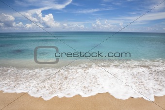 Empty beach with white wave spray