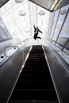 Happy businessman and Escalator in the modern building