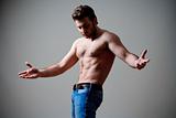 young shirtless musculous man in jeans - isolated on gray
