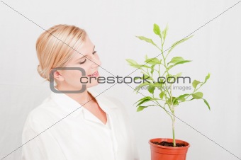 young female sciantist with green plant