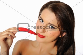 Beautiful sexy woman with red hot chilli pepper. isolated