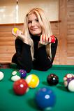 pretty woman with billiard ball in club