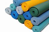 many colorfull yoga mats as a background. isolated on white
