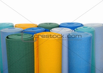 many colorfull yoga mats as a background. isolated on white