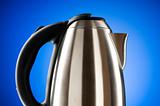 Shiny kettle against the colorful gradient background