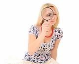 Attractive young blonde holding magnifying glass
