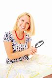 Beautiful young smiling girl with magnifying glass and map