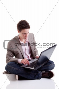 Young man typing and looking at screen of laptop, isolated on white, studio shot