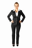 Full length portrait of smiling modern business woman with hands on hips
