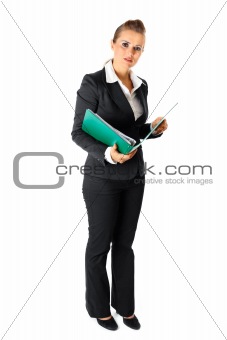 Serious modern business woman holding folders with documents
